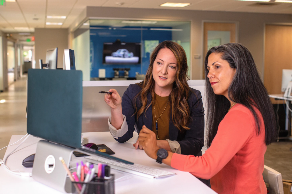 Recruitment executives at a firm looking at candidate profiles