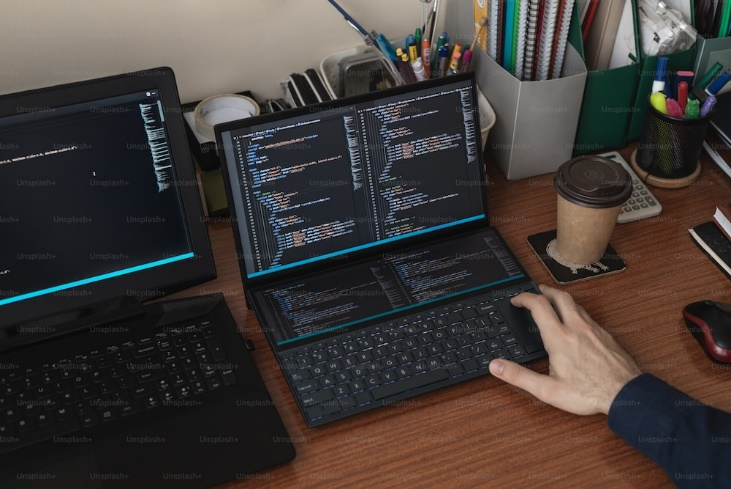 A person typing on a laptop on a desk