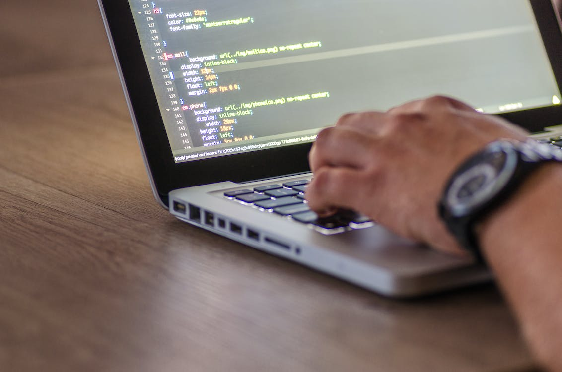 Software developer typing on a laptop