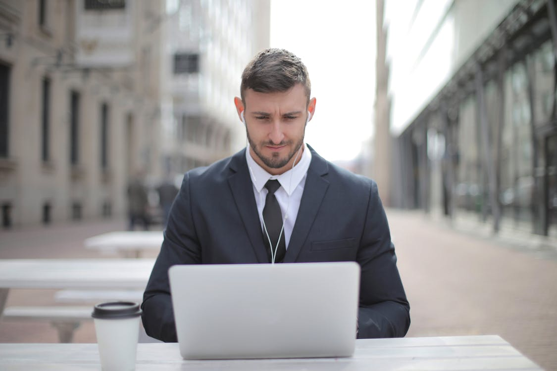 man in a suit using a laptop