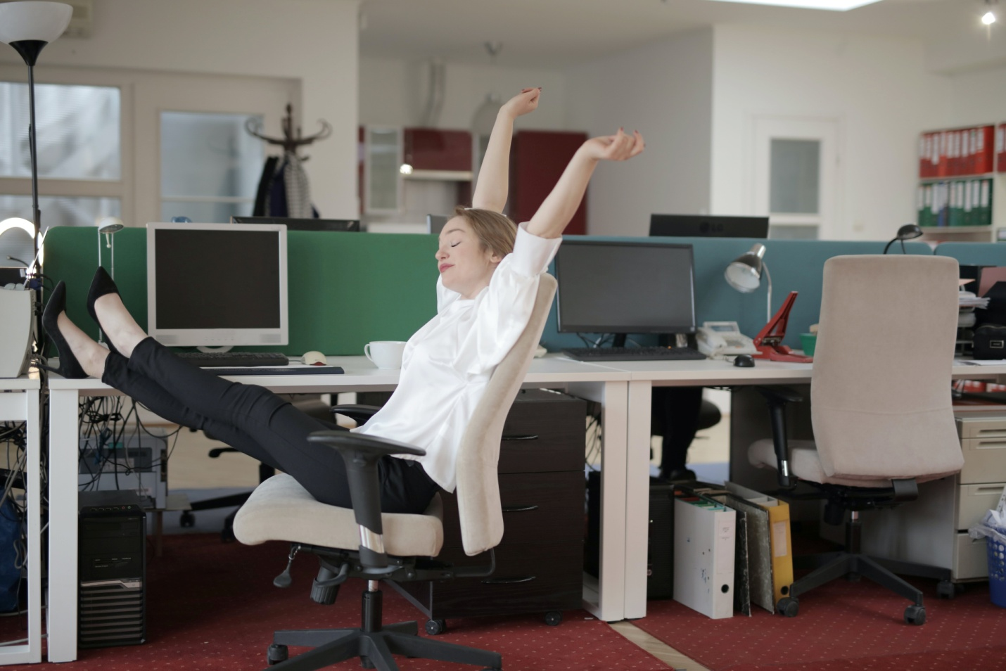 A woman stretching at work