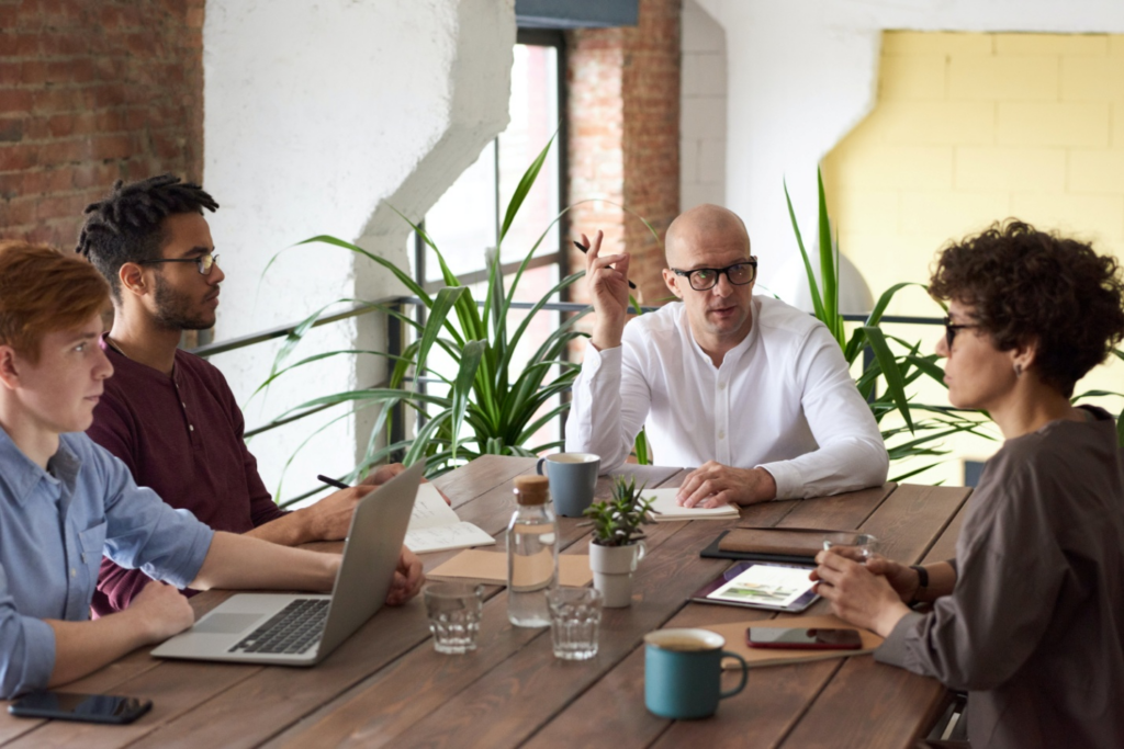 Four people having a meeting